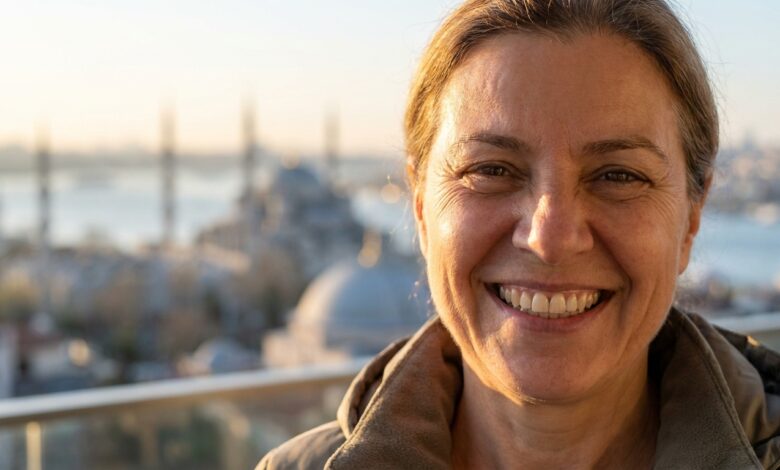 A close-up, photorealistic image of a happy mature person with a perfect smile, with the beautiful, blurred skyline of Istanbul and the Bosphorus visible in the background during a warm sunrise.