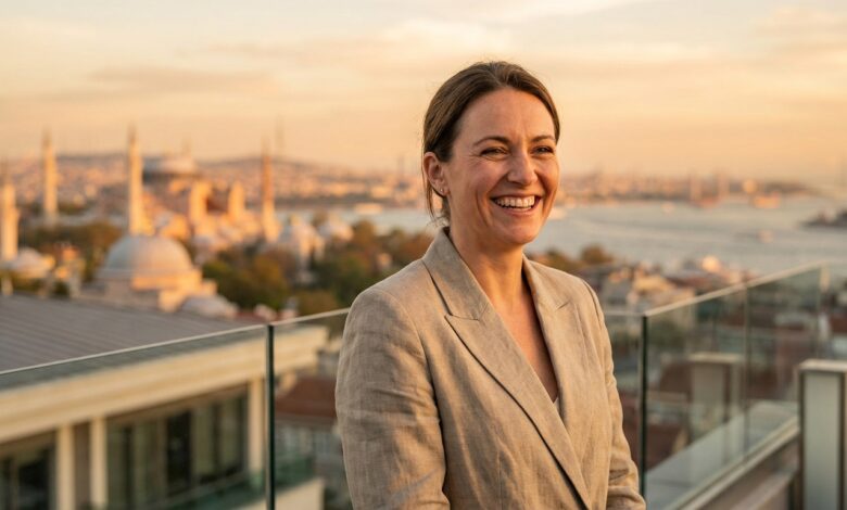 A close-up of a happy, confident person with a perfect white smile, standing on a balcony with a beautifully blurred background of the Istanbul, Turkey skyline at sunset.