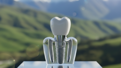 A photorealistic image of a detailed dental implant model showing the titanium post, abutment, and ceramic crown, resting on a clean, light surface. The background is a deeply blurred, soft-focus view of iconic green rolling hills or mountains of New Zealand, conveying the topic of dental implant costs and guidance in the region.