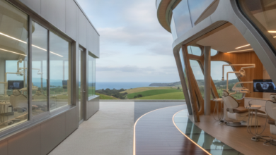 A photorealistic conceptual image showing a visual split between two distinct architectural styles, representing the contrast between public and private dental care systems. One side appears minimalist and functional, while the other is modern and technologically advanced, all set against a softly blurred, distant New Zealand landscape.