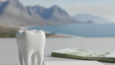 A close-up of a perfectly clean, healthy white tooth resting on a minimalist surface, next to a blurred stack of generic currency notes or an unbranded payment card. In the soft-focus background, a heavily blurred scenic landscape of New Zealand, possibly mountains or coastline. The image conveys the topic of dental health and financing without any text.