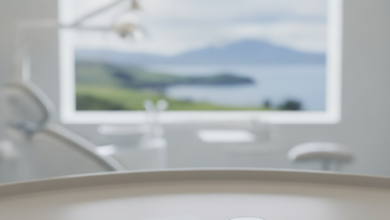 Close-up of a generic payment card and generic coins on a clean surface, with a blurred modern dental clinic and a very distant, blurred New Zealand landscape visible through a window in the background. No text or branding.