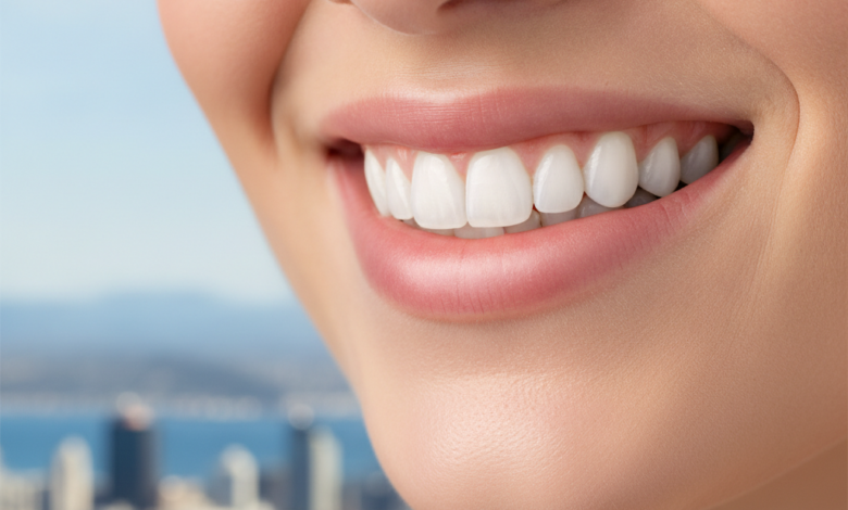 Close-up of a person's bright, confident smile with perfectly white, healthy teeth. The background is softly blurred, subtly revealing elements of the Wellington cityscape.