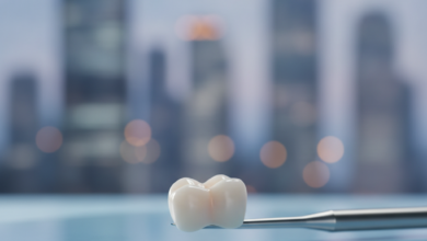 Close-up, photorealistic image of a polished zirconia dental crown, appearing naturally translucent, resting on a sterile, light-colored dental tray. The background is an extremely blurred, cool-toned urban cityscape at dusk, hinting at a modern professional clinic setting. The crown is sharply in focus, emphasizing its detail and quality.